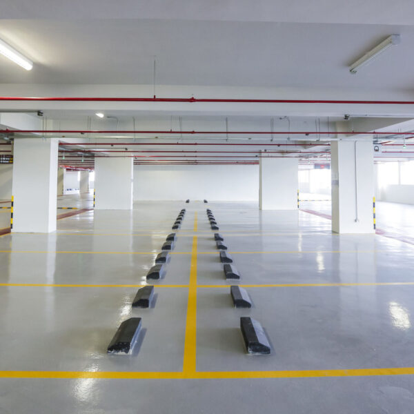 Empty indoor car parking space / lots.